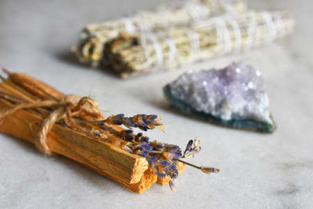 A close up image of a smudge sticks with dried lavender and amethyst crystals.の写真素材