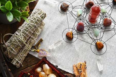 A top view image of a healing crystal grid using healing crystals and sacred geometry with white...