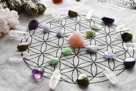 A close up image of a crystal healing grid using sacred geometry and a variety of healing crystals.の写真素材