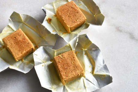 A top view image of three chicken flavored bouillon cubes used for seasoning.の写真素材