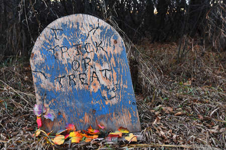 An image of an old weathered wooden tombstone used as a Halloween decoration.の写真素材