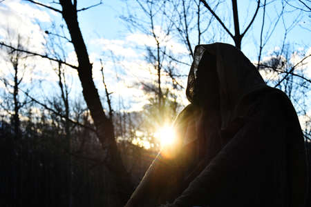 An image of a dark hooded ghoul set up as a Halloween display at an out door ghost walk.の写真素材