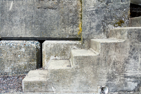 An abstract image of a set of concrete steps and retaining wall.