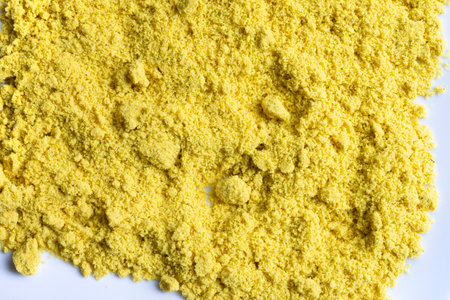 An abstract image of powered chicken soup bouillon on a white plate.の写真素材