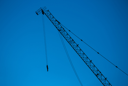 Construction crane and building in construction site の写真素材