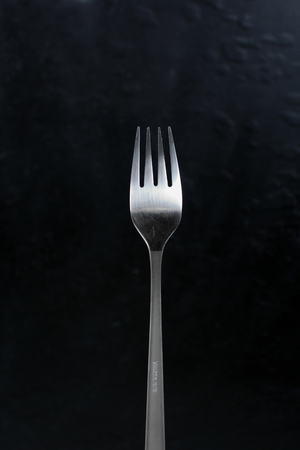 Fork for food. Isolated cutlery. Metallic fork with matte handle.