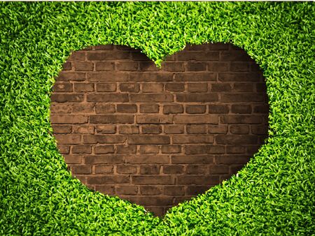the heart of the grass on a brick background the heart of the grass on a brick background