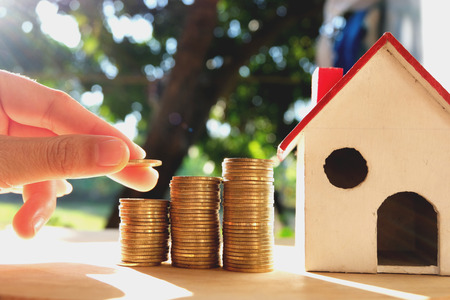 Coins placed on the wooden floor, Business Finance and Money concept, Save money for prepare in the future .Concepts saving money for House.の写真素材