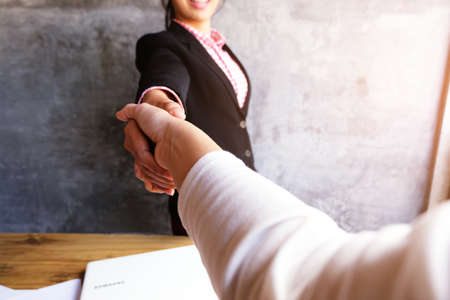Business people shaking hands, finishing up a meeting, concept of team work and cooperation.の写真素材
