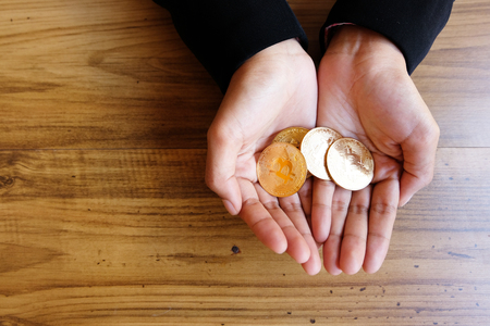 Businessman holding bit coin Investment Savings Ideas, save money aside for an emergency, Ideas about saving money for future use.の写真素材