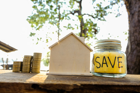 Coins placed on the wooden floor, Business Finance and Money concept, Save money for prepare in the future .Concepts saving money for House.の写真素材
