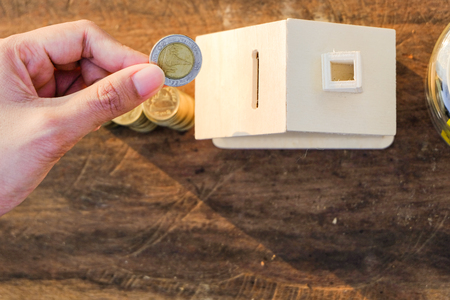Coins placed on the wooden floor, Business Finance and Money concept, Save money for prepare in the future .Concepts saving money for House.の写真素材