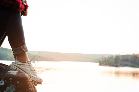 Relaxing moments, Young woman reading a book by the lake. Solo relaxation, color of Hipster Tone.の写真素材