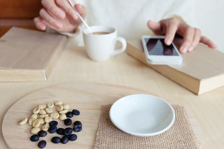 Relaxing moments , Cup of coffee and a book on wooden table in nature background, color of vintage tone and soft focus, winter morning concept.の写真素材