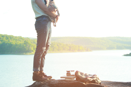 A girl and her dog enjoying travel in nature background  the sunset, color of vintage tone and soft focusの写真素材