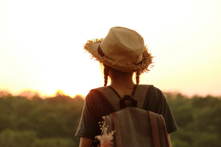 Happy  female with backpack tourist to travel in nature during vacation. Travel concept.の写真素材