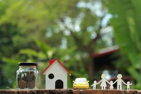 Paper cut of family on green grass, Concepts saving money for House and car, Vintage tone.の写真素材