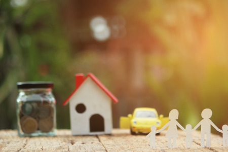 Paper cut of family on green grass, Concepts saving money for House and car, Vintage tone.の写真素材