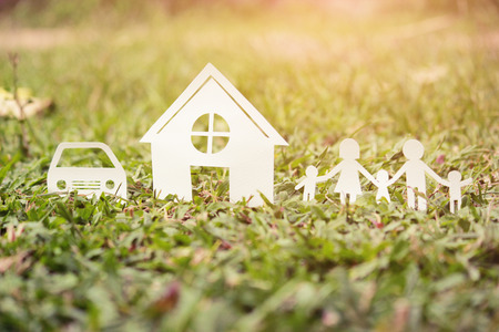 Paper cut of family on green grass, Concepts saving money for House and car, Vintage tone.の写真素材