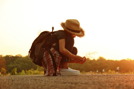 Happy  female with backpack tourist to travel in nature during vacation. Travel concept.の写真素材