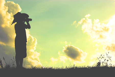 A silhouette of a little child pretend to be pirate. Kid having fun at sunset. Summer vacation and travel conceptの写真素材