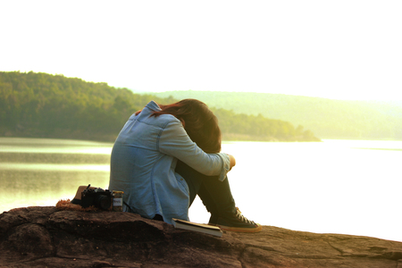 Young woman traveling alone, emotional loneliness , heartbroken ,concept travel, color of vintage tone and soft focus.の写真素材