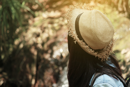Beautiful woman and camera with backpack in the jungle on the mountain. concept travel, color of vintage tone and soft focus.の写真素材