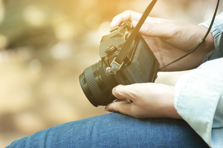 Beautiful woman and camera with backpack in the jungle on the mountain. concept travel, color of vintage tone and soft focus.の写真素材