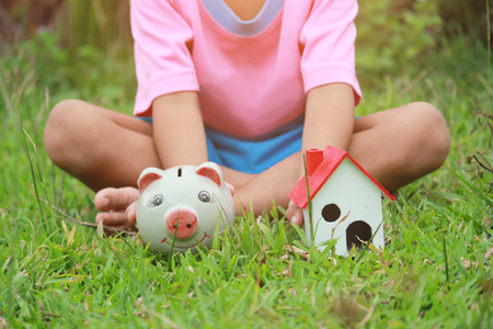 Asian kid, Save money set by children's hands put coins.Concept of saving money for Future, soft focus.の写真素材