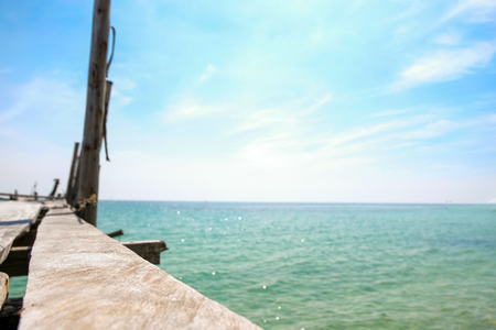 Perspective view of Old wooden bridge extending into the sea. holiday and summer scene.の写真素材