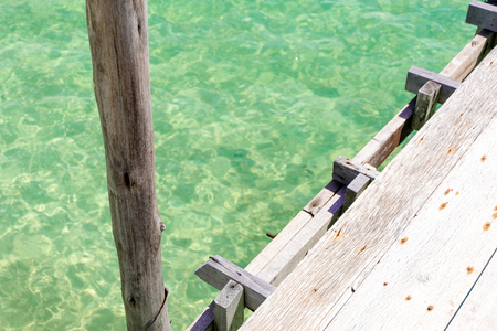 Perspective view of Old wooden bridge extending into the sea. holiday and summer scene.の写真素材