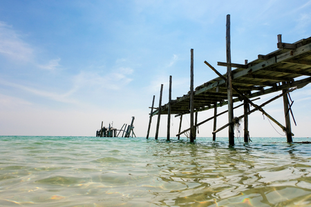 Perspective view of Old wooden bridge extending into the sea. holiday and summer scene.の写真素材