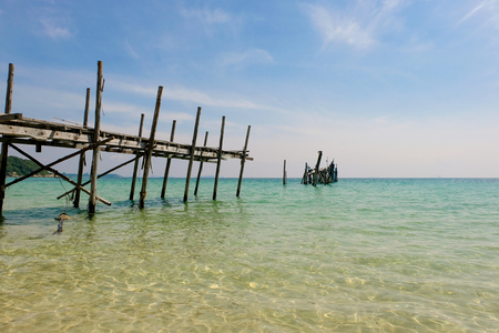 Perspective view of Old wooden bridge extending into the sea. holiday and summer scene.の写真素材