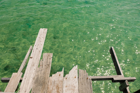 Perspective view of Old wooden bridge extending into the sea. holiday and summer scene.の写真素材
