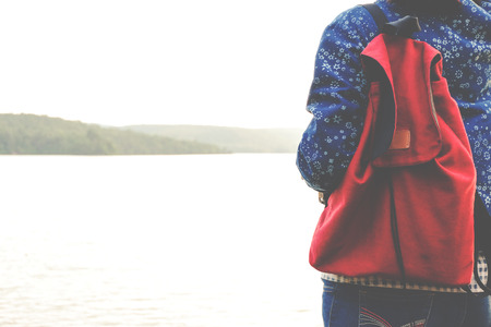 Relaxing moments, Asian young girls with bright backpack enjoying in nature during vacation. Travel Lifestyle adventure concept vacations into the wild. Hipster tone style.の写真素材