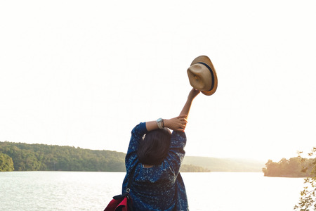 Relaxing moments, Asian young girls with bright backpack enjoying in nature during vacation. Travel Lifestyle adventure concept vacations into the wild. Hipster tone style.の写真素材