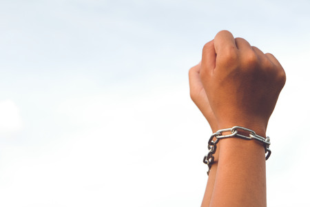 Hands are not free was locked by chain, Lack of freedomの写真素材