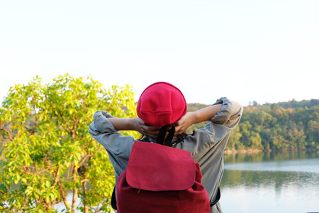 Traveler young girl with backpack walking on path in the tropical forest, Relax time on holiday concept travel, Thailand.の写真素材