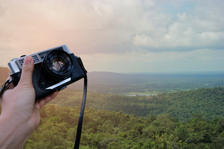 Traveler in nature with camera travel photo of photographer. Travel Lifestyle adventure concept vacations into the wild.の写真素材