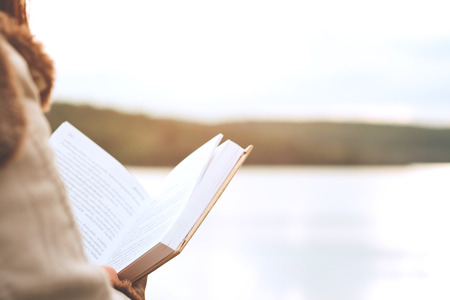 Relaxing moments, Young women opening and reading book enjoys of rest outdoor with summer vacations and lifestyle concept.の写真素材