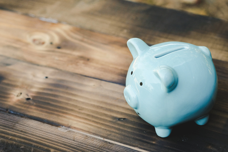 Blue piggy bank on old wooden floor. ideas about saving money for future use - business success concept.の写真素材