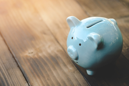 Blue piggy bank on old wooden floor. ideas about saving money for future use - business success concept.の写真素材