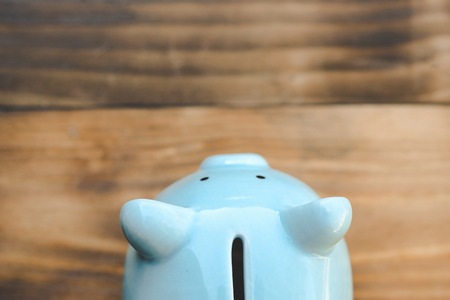 Blue piggy bank on old wooden floor. ideas about saving money for future use - business success concept.の写真素材