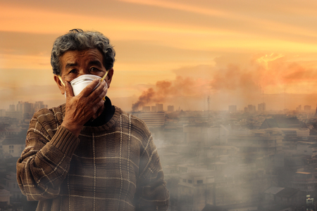 old woman wearing face mask because of air pollution in the city has a health effect. Ecology, Environmental awareness and virus protection concept, healthcare conceptの写真素材