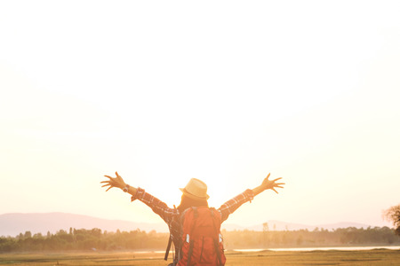 Tourist woman relaxing alone with a large backpack enjoying in lake view. Travel wanderlust lifestyle concept adventure vacations outdoor, Summer holiday and vacation tripの写真素材