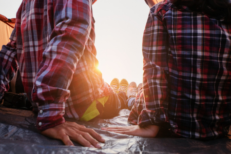 Two people lying in tent with a lake view from tent camping entrance outdoor. Travel wanderlust lifestyle concept adventure vacations outdoor, Summer holiday and vacation tripの写真素材