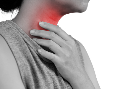 young woman having sore throat and touching his neck, hand at his neck, feeling unwell,  hard to swallow - Healthcare and health insurance concept - isolated on white background with clipping path.の写真素材