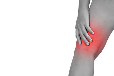 Inflammation colored in red suffering injured leg, healthcare and problem concept - isolated on white background with clipping path.の写真素材