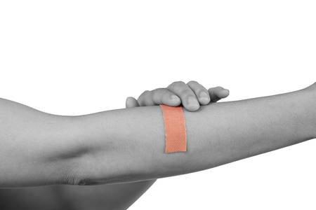 Hand women with adhesive plaster that covering a slight injury - isolated on white background with clipping path.の写真素材