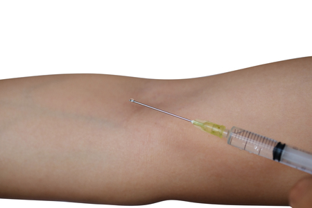 Disposable syringe with the drug in female hand injecting himself in the arm, Inoculation - isolated on white background with clipping path.の写真素材